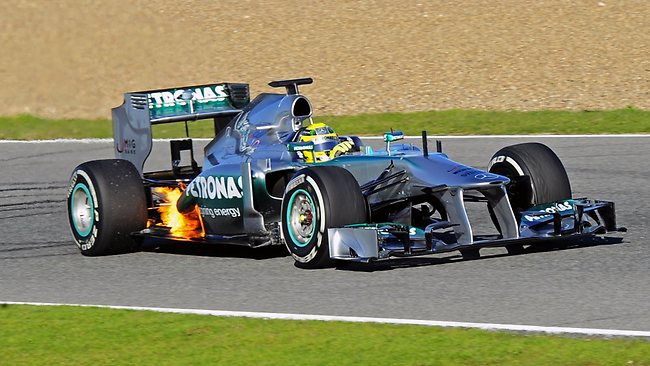 Flames are very visible around the rear end of the car driven by Rosberg.