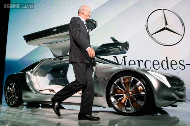 Dr. Dieter Zetsche walks towards the F125 Mercedes-Benz concept car during its unveiling at the 2011 Frankfurt Auto Show.